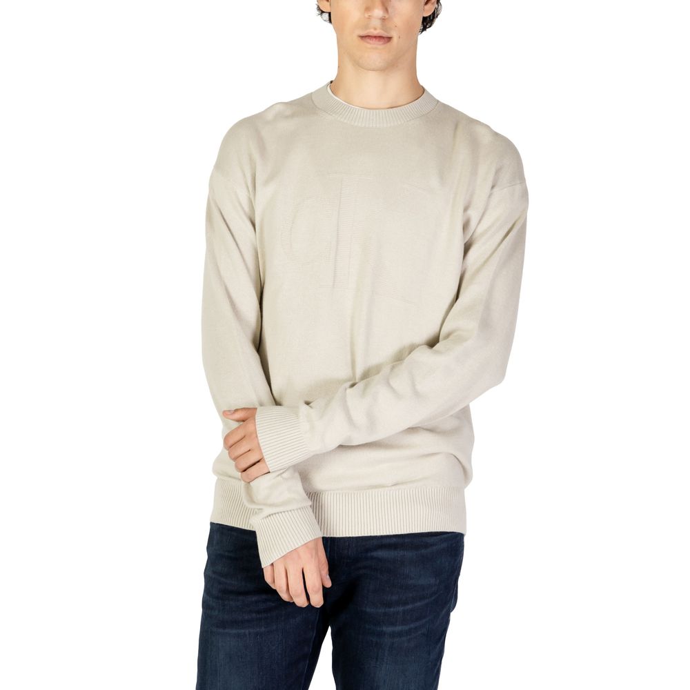 Calvin Klein Jeans Beige Organic Cotton Sweatshirt worn by model showcasing intarsia logo and comfortable fit