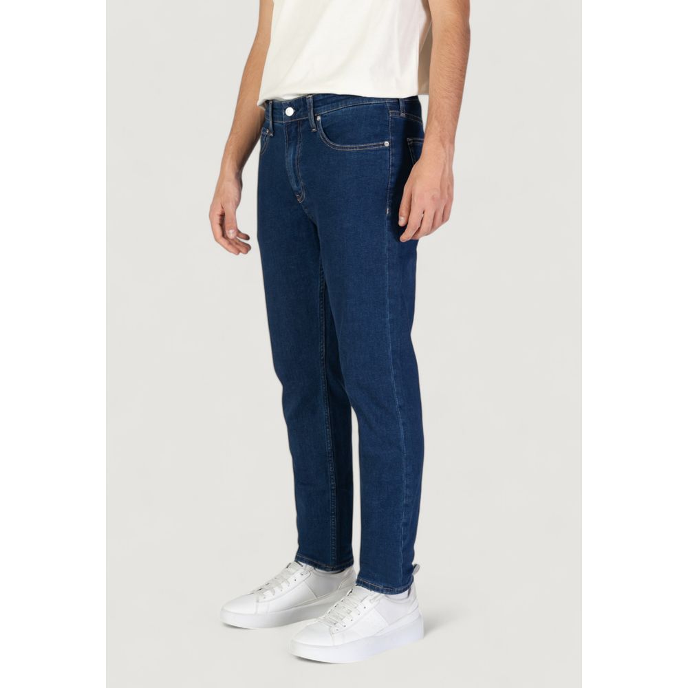 Calvin Klein Jeans Blue Cotton Slim Fit Jeans modeled with casual white shoes
