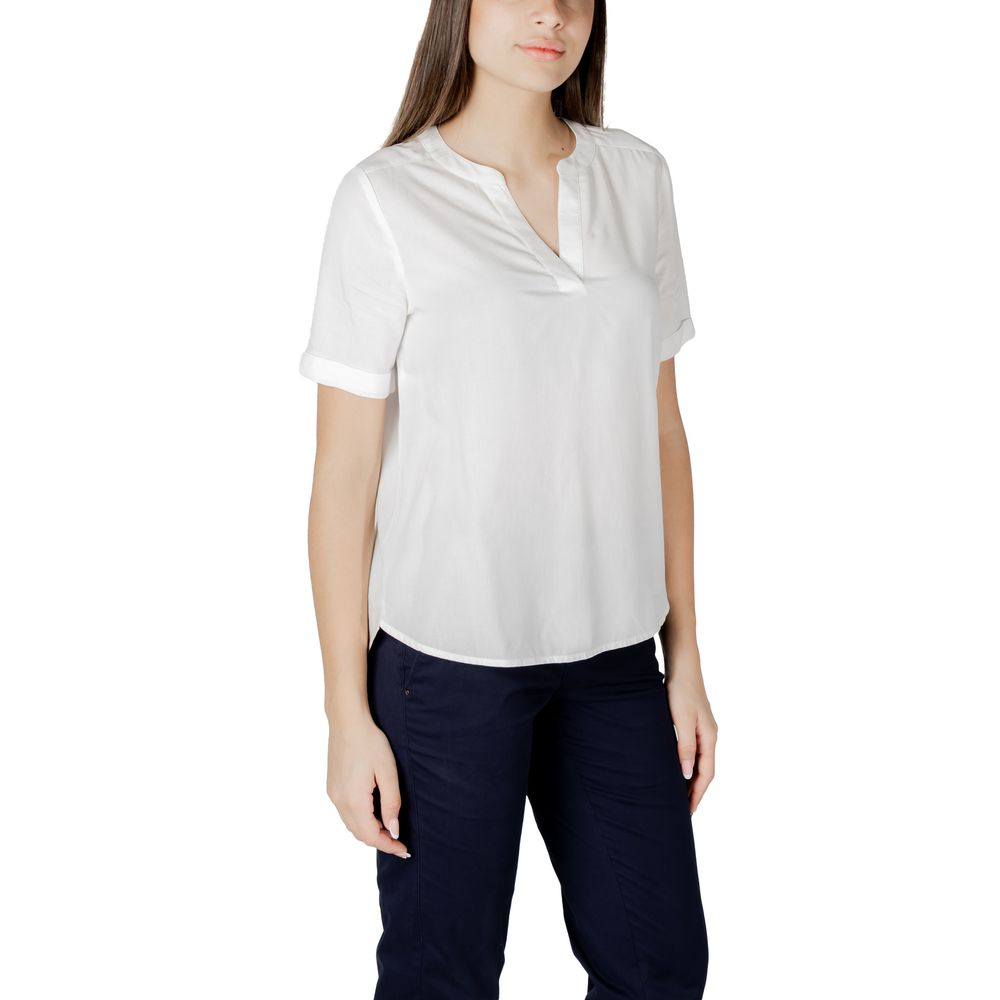 Woman wearing a Street One White Viscose Blouse with short sleeves and V-neckline, paired with dark trousers for a casual look.