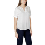 Woman wearing a Street One White Viscose Blouse with short sleeves and V-neckline, paired with dark trousers for a casual look.