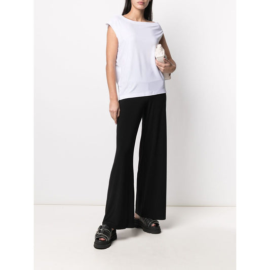 Norma Kamali Trousers Black in stretch mid-rise wide-leg design worn with sandals.
