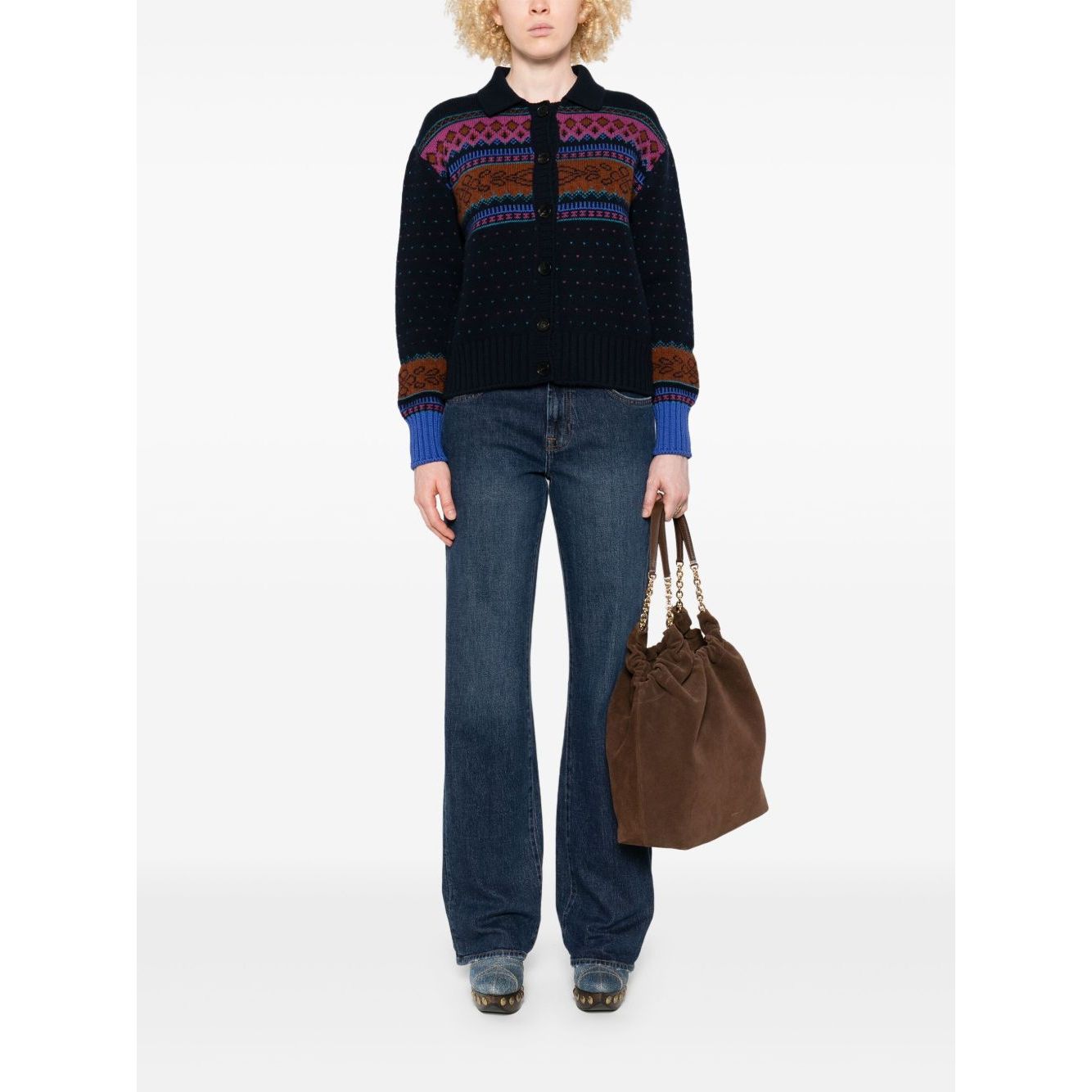 Woman wearing Seven Jeans Blue denim with navy five pockets, belt loops, button fly, and wide-leg design, holding a brown bag.