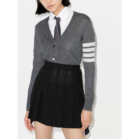 Model wearing Thom Browne Sweaters Grey wool cardigan with V-neck, button fastening, long sleeves, ribbed cuffs, and 4Bar detail.