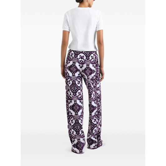 Model wearing white Dolce & Gabbana Logo cotton t-shirt with patterned pants, rear view, showcasing short sleeves and straight hem design.