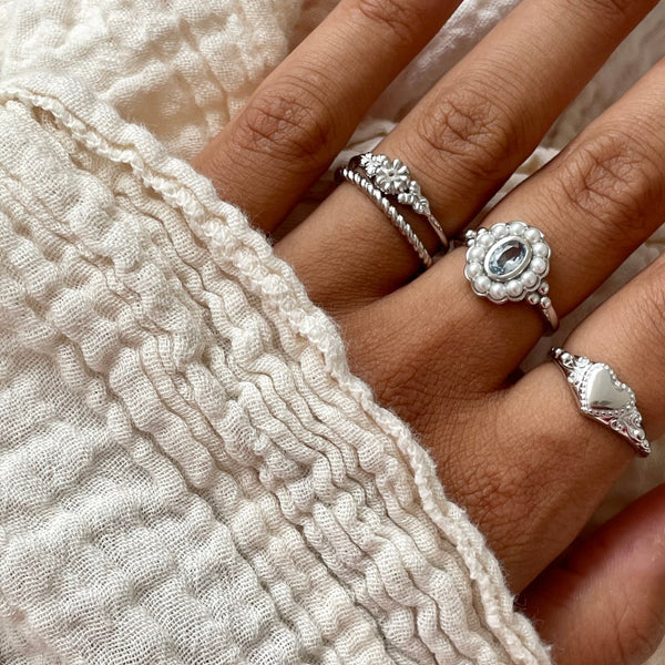 Person wearing silver rings, close-up view, displaying elegant 24KAE JEWELS JEWELRY Mod. 12416S/56 design.