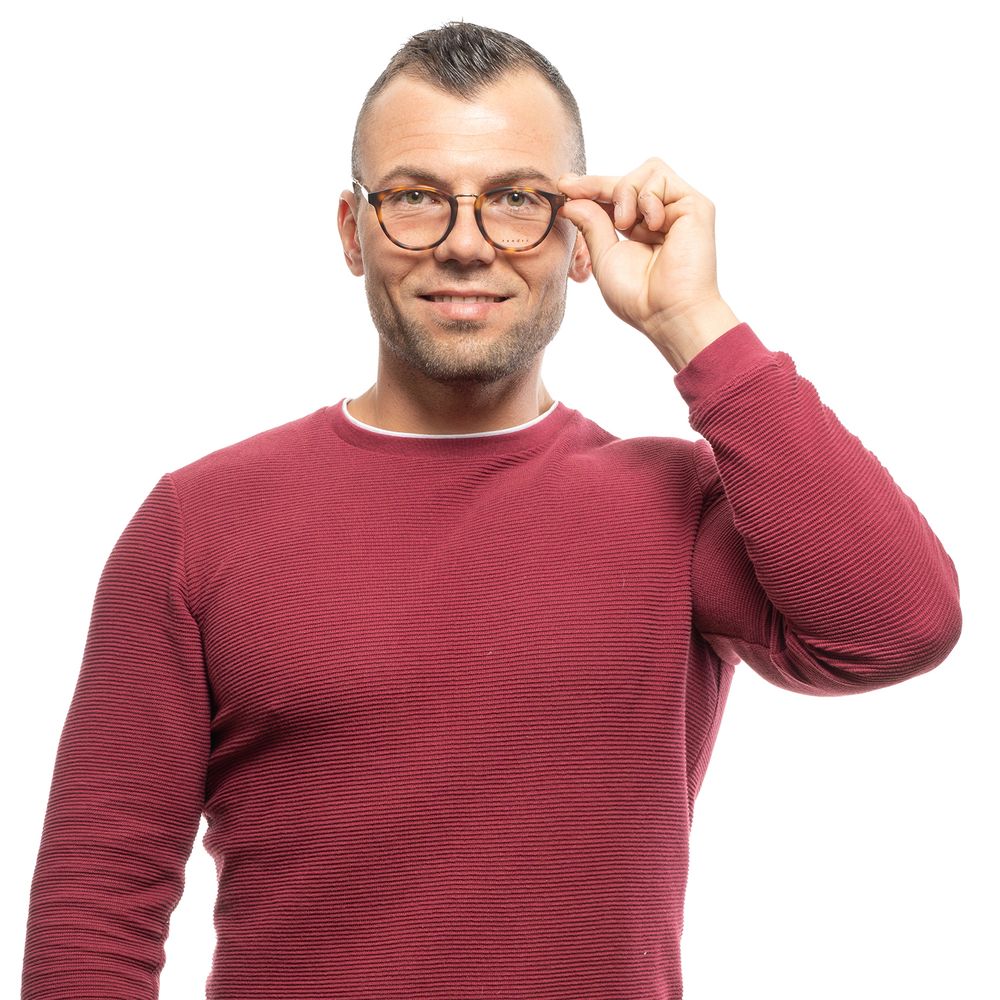 Man wearing Sandro Brown Men Glasses Frame, round brown full-rim plastic frame with 49-19-145 dimensions, smiling in a red sweater.
