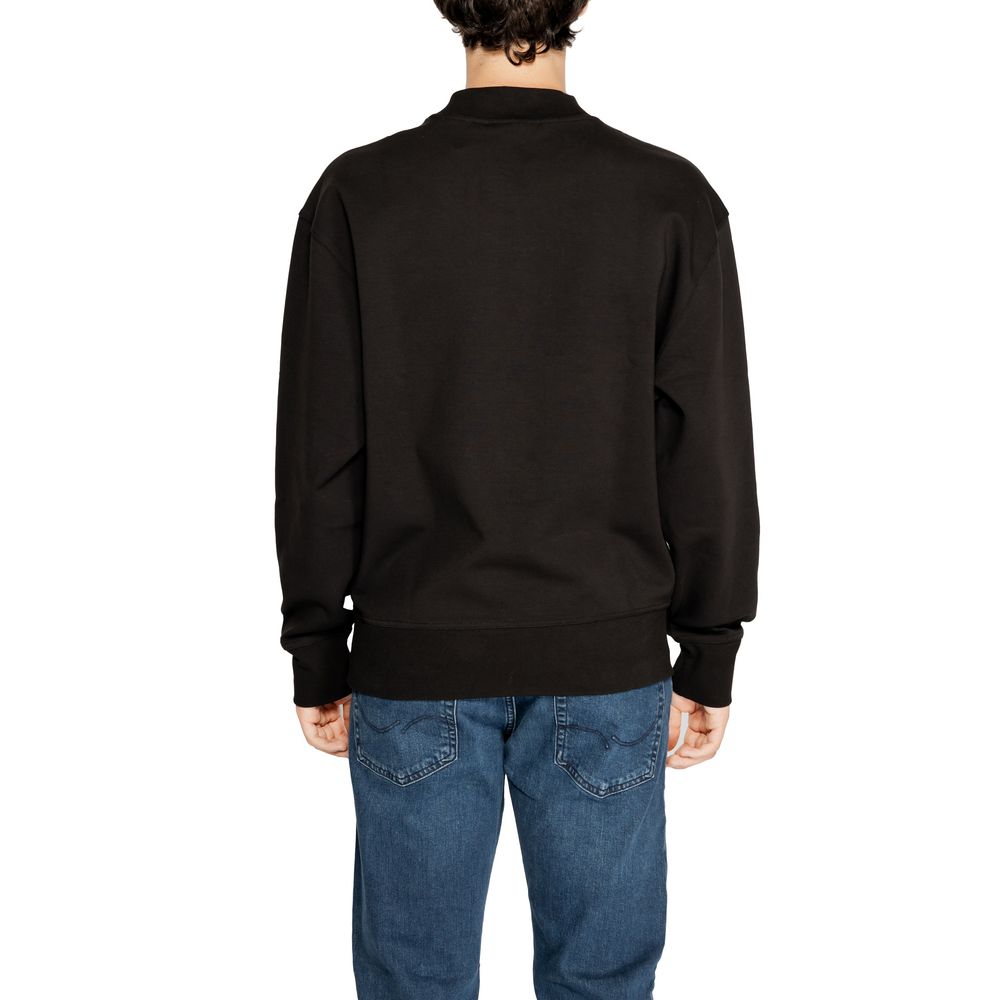 Back view of Calvin Klein Jeans Black Recycled Cotton Sweatshirt on male model wearing blue jeans.