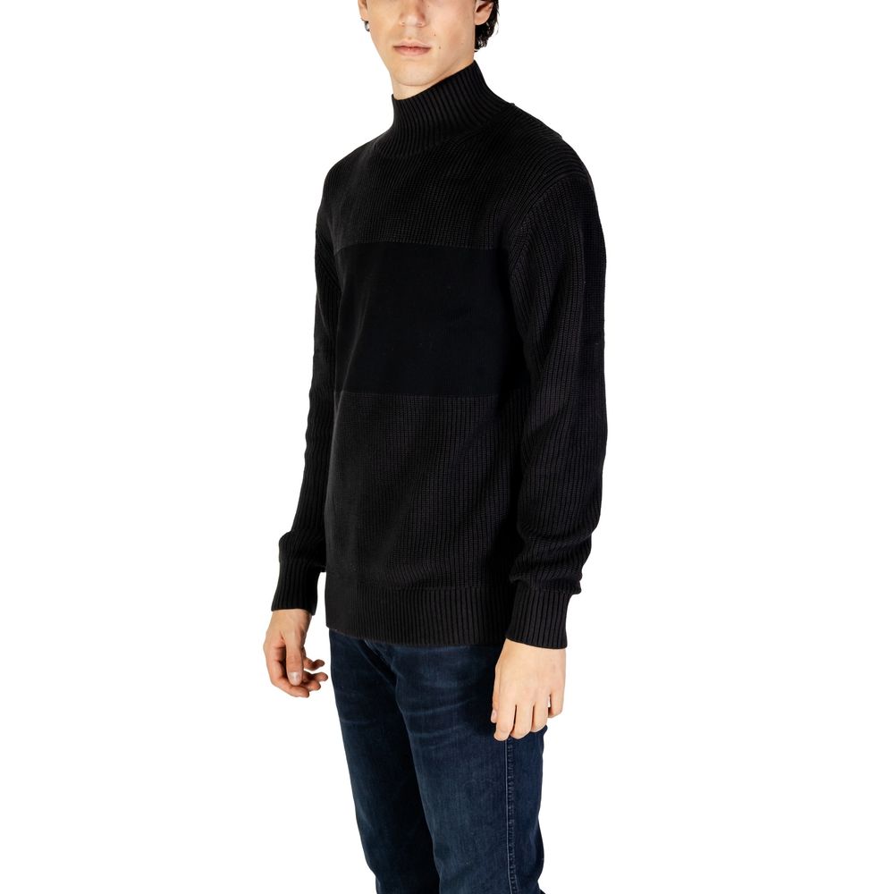 Model wearing Calvin Klein Jeans Black Cotton Sweatshirt with mixed ribbed knit, high neckline, and comfortable fit.