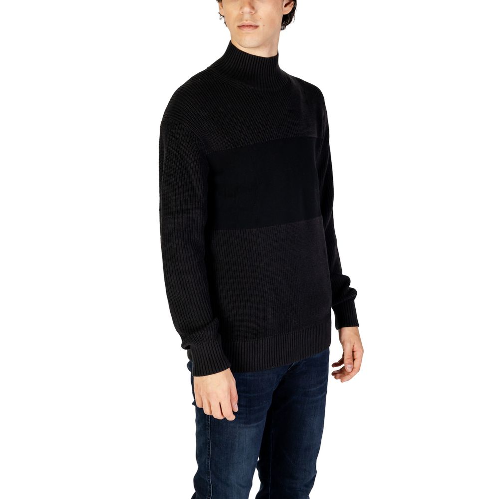 Model wearing Calvin Klein Jeans Black Cotton Sweatshirt with high neckline and ribbed knit design.