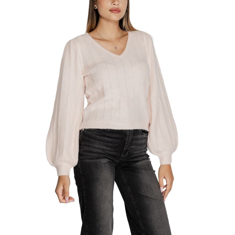 Model wearing Guess Pink Polyester Sweatshirt with ribbed texture and modern V-neckline, paired with dark jeans.