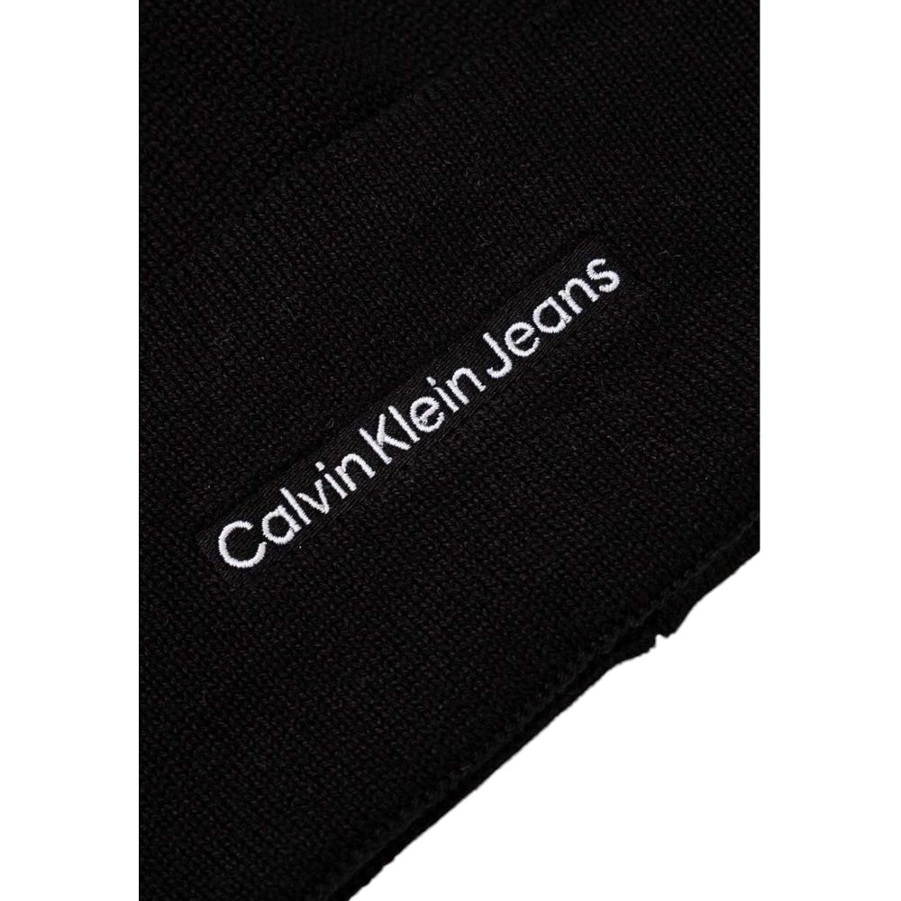 Close-up of Calvin Klein Jeans Black Cotton Cap (Baseball Hat) showing embroidered logo on black fabric.