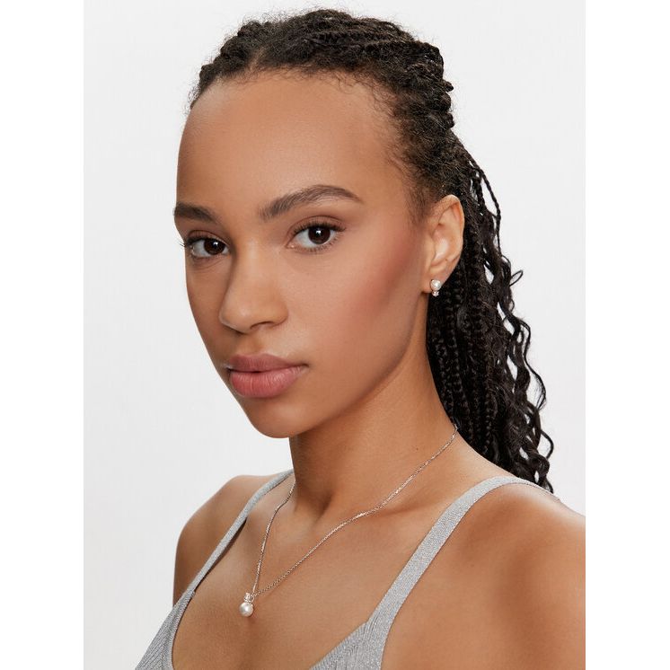 Woman wearing SWAROVSKI Mod. 5689624 earrings, silver 925°, quartz analog movement, mineral dial, 38mm case, water resistant 5 ATM.