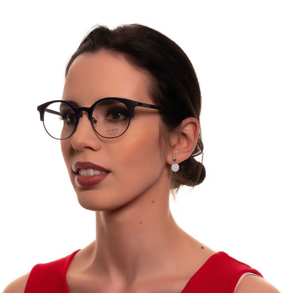Woman wearing Guess Black Women Glasses Frame in black round style with full-rim design and metal-plastic frame featuring spring hinge.