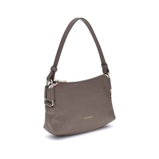 Coccinelle Rebekka Shoulder Bag in taupe leather with top zip closure and adjustable strap, showcasing iconic front logo.