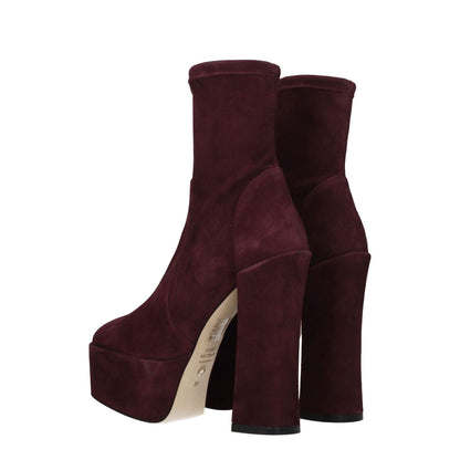 Stuart Weitzman Purple Leather Ankle Boots with high heels and round toes, made from suede with leather soles, back view