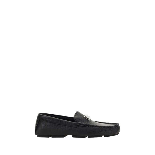 Dolce & Gabbana Black Rubber Slip-On Loafers with calfskin upper and iconic metal monogram plaque on a flat non-slip sole.
