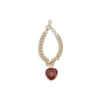 Valentino Garavani Gold Brass Bracelet with black heart-shaped charm, VLogo embellishment, and lobster clasp for elegant style.