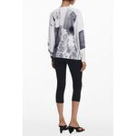 Back view of Desigual White Viscose Women Sweater with artistic patterns and classic V-neck.