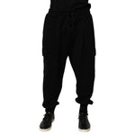 Men wearing Dolce & Gabbana Black Cotton Blend Cargo Joggers Drawstring Pants with elastic waistband and side pockets.