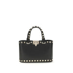 Valentino Garavani Mini Shopping Rockstud in grained calfskin with platinum-finished studs, handles, chain strap, and nappa lining.