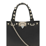 Valentino Garavani Mini Shopping Rockstud bag with platinum finish studs and chain, crafted from grained calfskin.