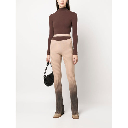 Woman wearing ANDREĀDAMO Andrea Adamo Trousers Brown, high-waisted ribbed design with ombré effect and cut-out detailing, styled for size S.