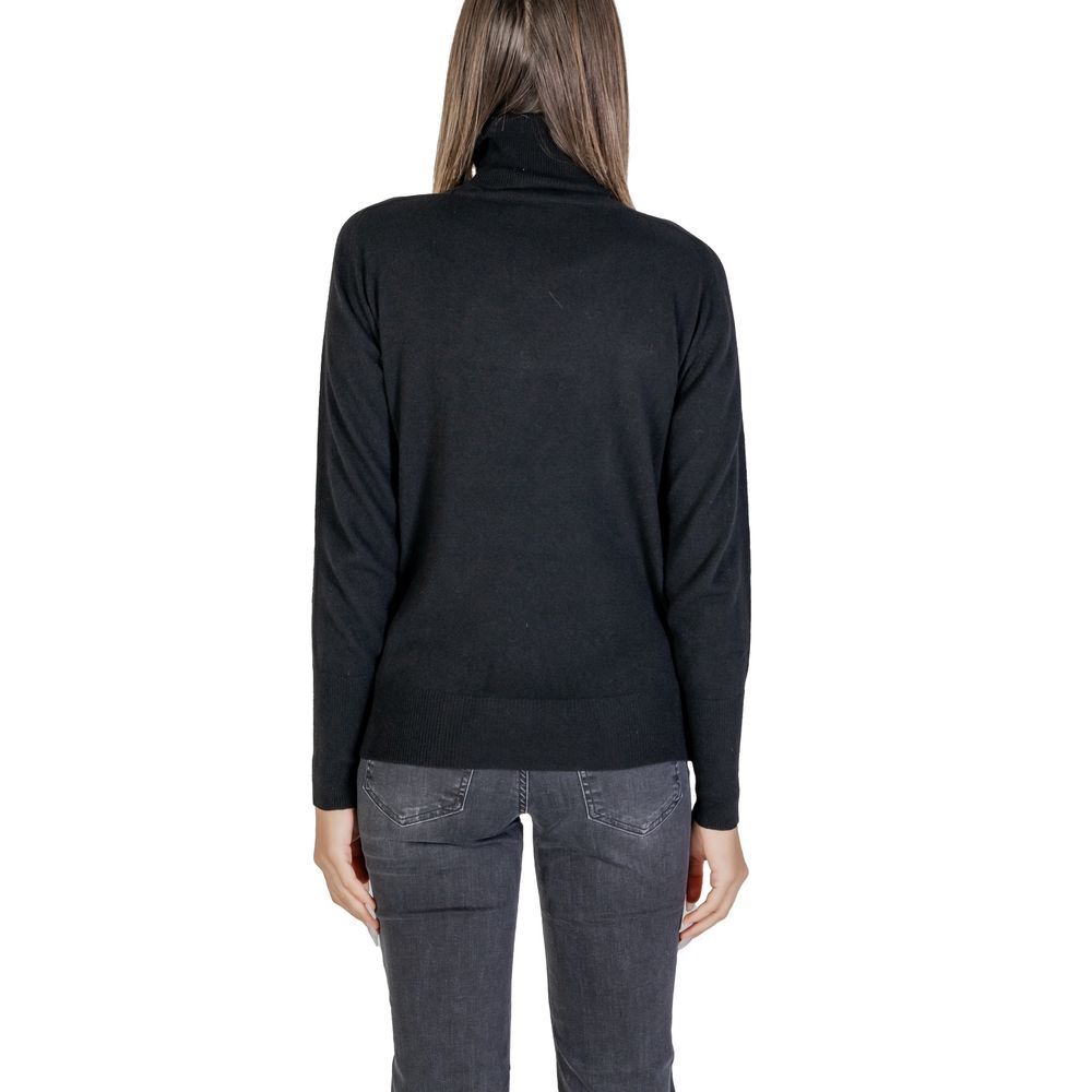 Back view of Alviero Martini Prima Classe Black Viscose Turtleneck on model, showcasing high-neck design and soft knit material.