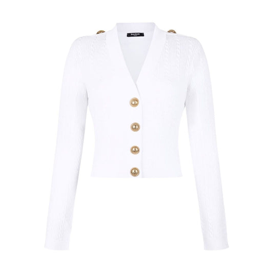 Balmain Button-Trim Cable-Knit Cardigan in white with gold shoulder and front buttons, V-neck, long sleeves, ribbed knit design.