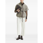 Model wearing Brunello Cucinelli Curly Shearling Short Sleeve Outerwear with Shiny Zipper Pull, displaying chic winter fashion.