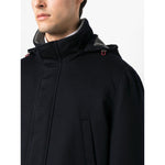 Man wearing a midnight blue Brunello Cucinelli Detachable hood padded coat with stand-up collar and belted cuffs.