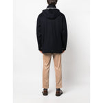 Back view of person wearing Brunello Cucinelli Detachable hood padded coat with brown pants, in a neutral background.