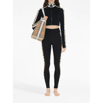 Woman wearing Burberry Stretch jersey leggings with Check finishes, featuring black stretch-jersey and Vintage Check pattern details.