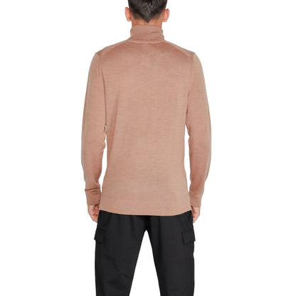 Back view of a model wearing Calvin Klein Beige Wool Turtleneck sweater, showcasing elegant design and comfort. Perfect winter wardrobe piece.