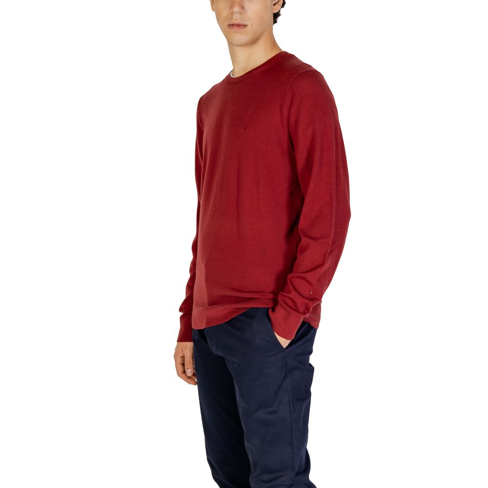 Man wearing Calvin Klein Bordeaux Recycled Wool Sweatshirt with crew neck, regular fit, and ribbed finishes.