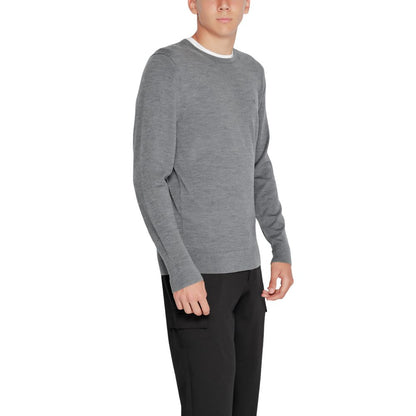 Model wearing Calvin Klein Gray Recycled Wool Sweatshirt with crew neck and ribbed finishes.