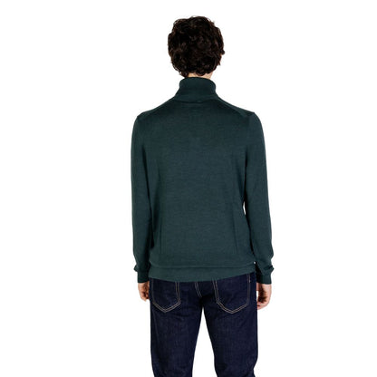Back view of a model wearing a Calvin Klein Green Wool Turtleneck, showcasing its stylish and refined design for winter fashion.