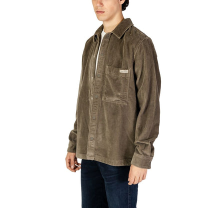 Calvin Klein Jeans Beige Denim Shirt with corduroy texture and chest pocket, modeled by a man in casual jeans.