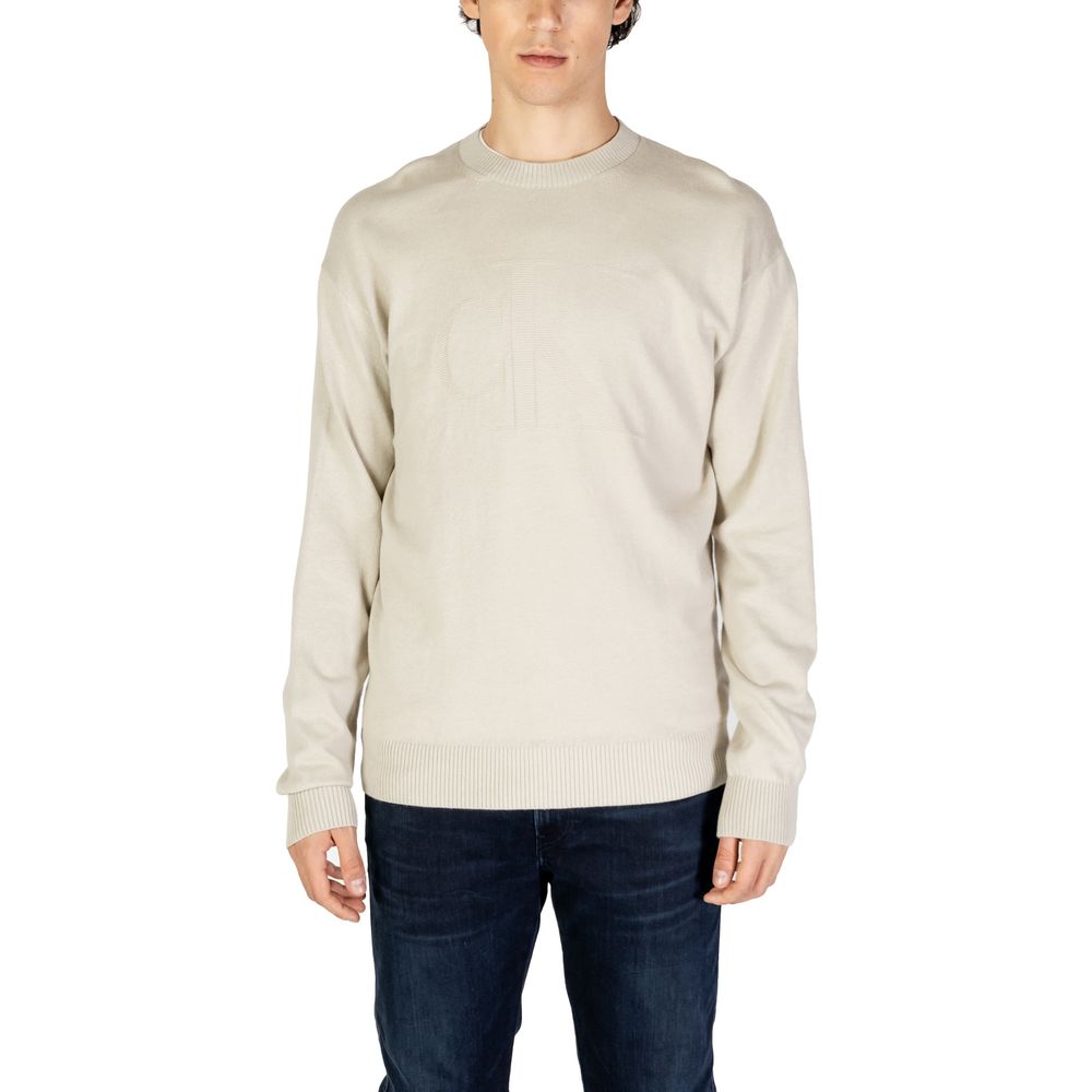 Calvin Klein Jeans Beige Organic Cotton Sweatshirt worn by model, featuring a tone-on-tone CK logo, elegant and comfortable design for men.