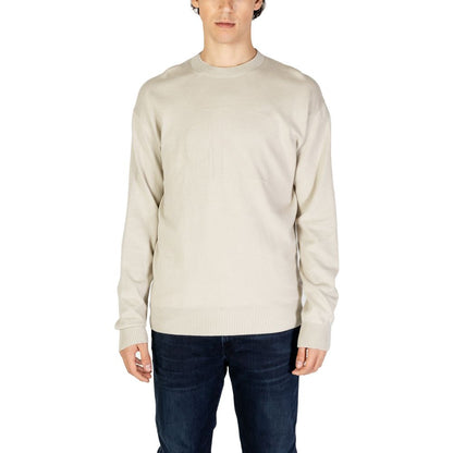 Calvin Klein Jeans Beige Organic Cotton Sweatshirt worn by model, featuring a tone-on-tone CK logo, elegant and comfortable design for men.
