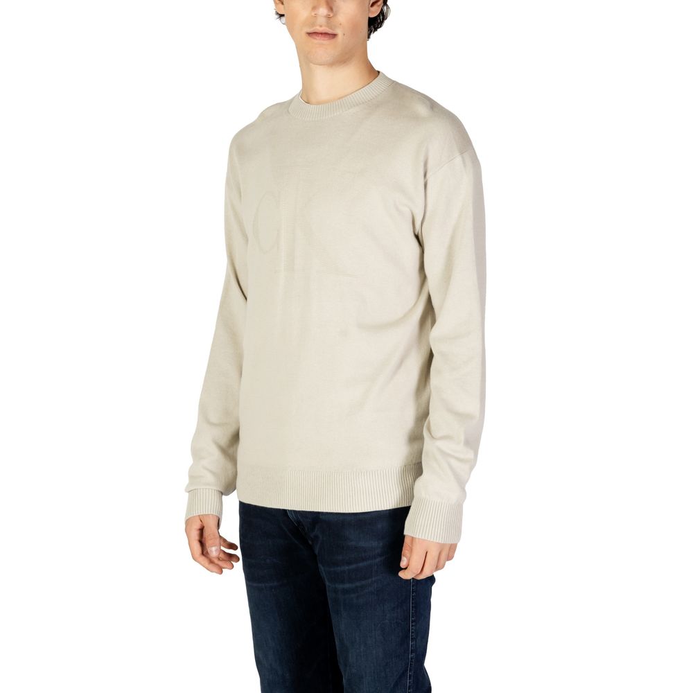 Calvin Klein Jeans Beige Organic Cotton Sweatshirt on model, showcasing minimalist design and CK logo intarsia for men.