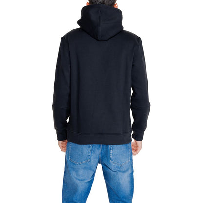 Back view of a person wearing Calvin Klein Jeans Black Cotton Hoodie with adjustable drawstring hood and kangaroo pocket for men