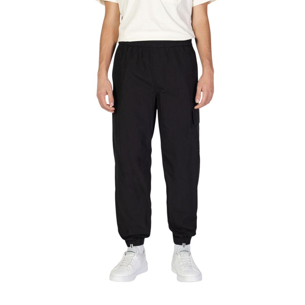 Calvin Klein Jeans Black Cotton Joggers (Workout Pants) showcased on a model, featuring a comfortable fit with practical utility pockets and elastic waistband.