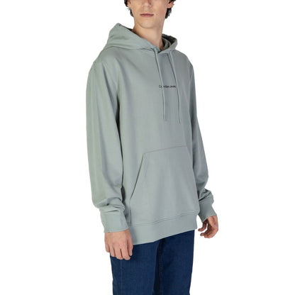 Calvin Klein Jeans Green Cotton Hoodie worn by a model, showcasing the urban and contemporary style of the men's monogram design.