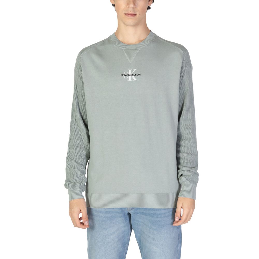 Calvin Klein Jeans Green Cotton Sweatshirt on male model with ribbed cuffs and crew neck design.