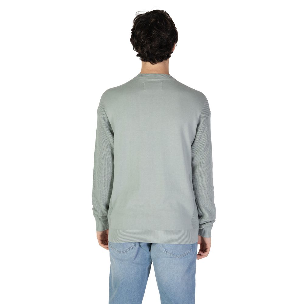 Back view of Calvin Klein Jeans Green Cotton Sweatshirt worn by man with blue jeans