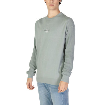 Man wearing Calvin Klein Jeans Green Cotton Sweatshirt with ribbed cuffs and hem, featuring iconic logo on chest.