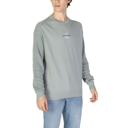 Model wearing Calvin Klein Jeans Green Cotton Sweatshirt with ribbed crew neck and logo, perfect for casual occasions.
