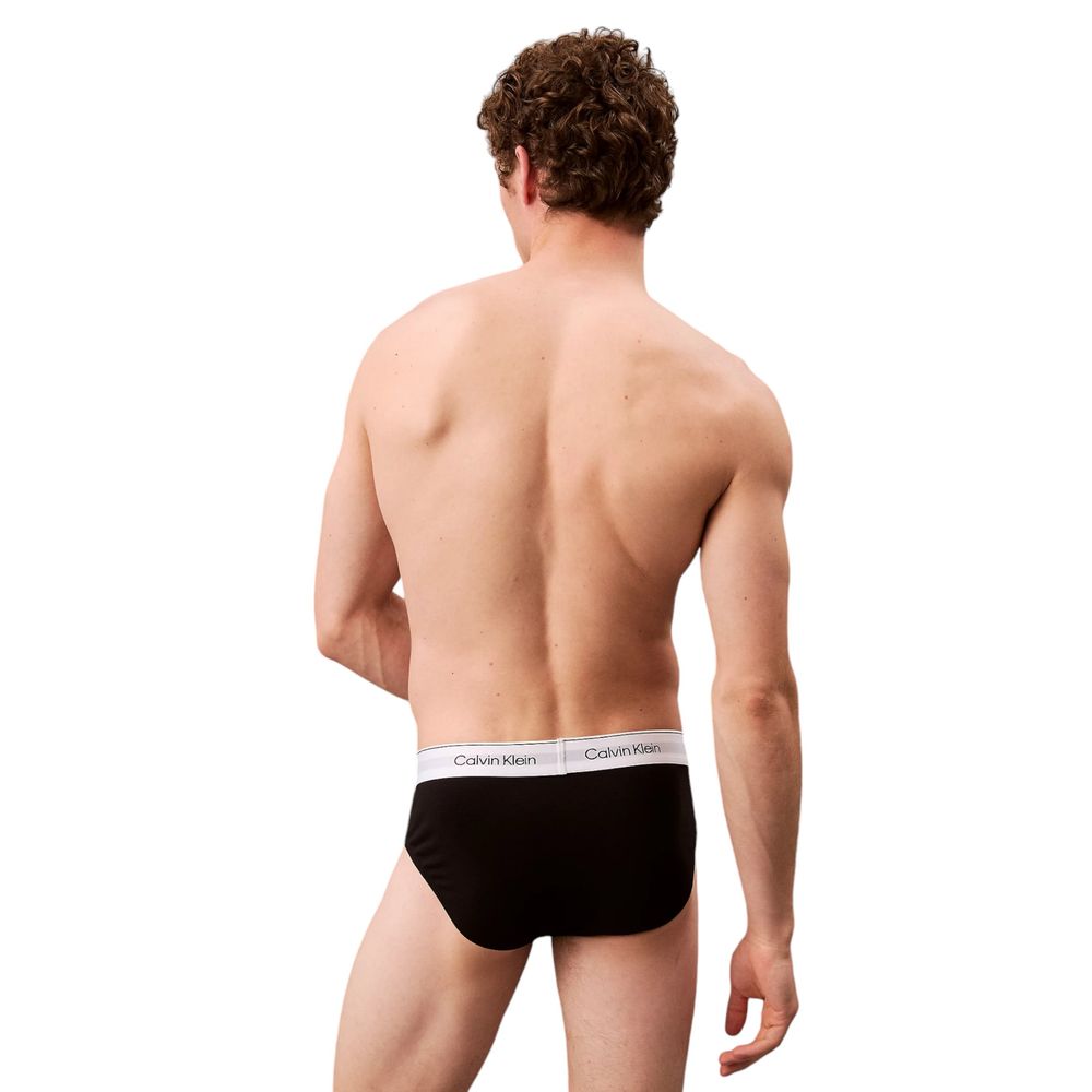 Back view of a man wearing Calvin Klein Underwear Black Cotton Briefs with logo waistband, showcasing fit and comfort.