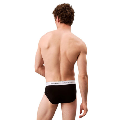 Back view of a man wearing Calvin Klein Underwear Black Cotton Briefs with logo waistband, showcasing fit and comfort.