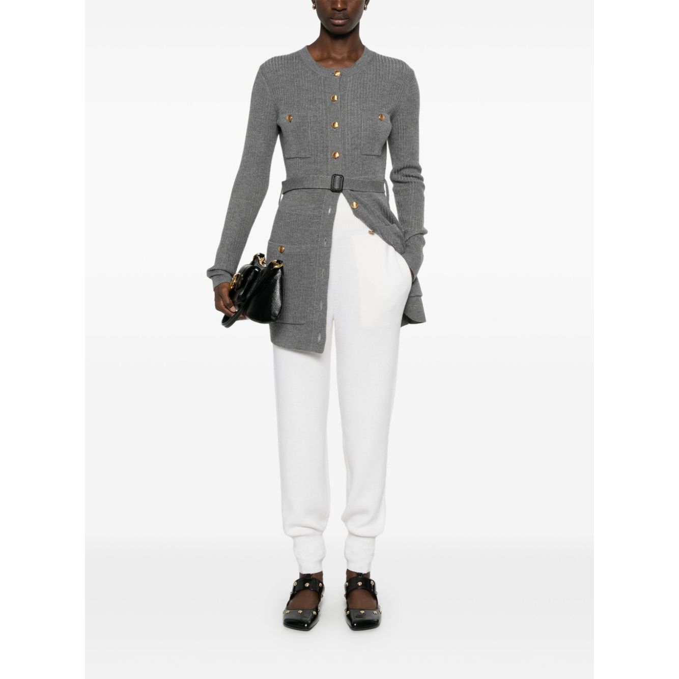 Model wearing Chloé Chloè Trousers White in cream wool with ribbed waistband and pockets, styled with a grey cardigan and black shoes.